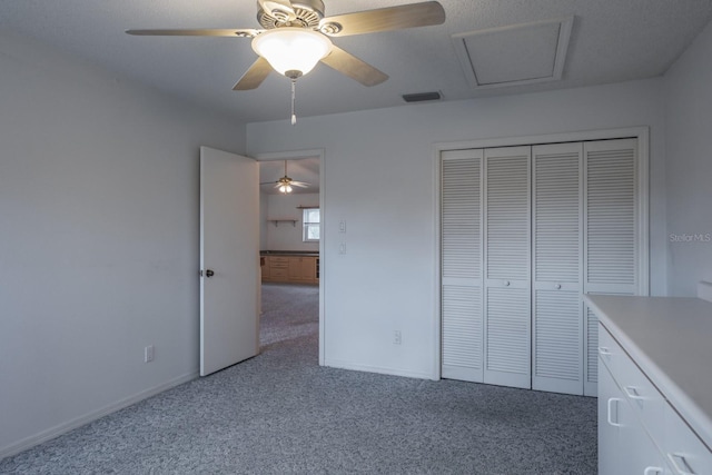 unfurnished bedroom featuring ceiling fan, a closet, and light carpet