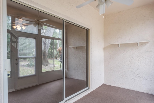 unfurnished sunroom featuring ceiling fan