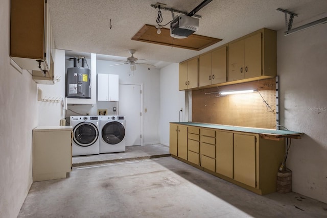 garage featuring ceiling fan, washing machine and clothes dryer, a garage door opener, and electric water heater