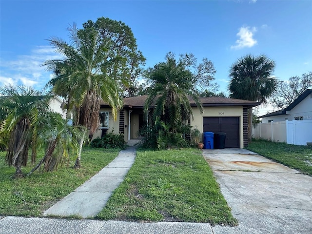 view of front of property with a garage and a front lawn