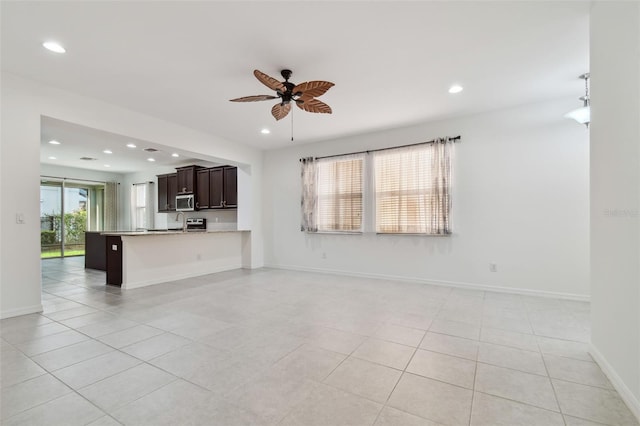 unfurnished living room featuring baseboards, light tile patterned flooring, a ceiling fan, and recessed lighting