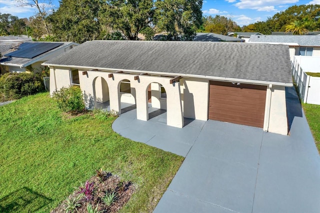 view of front facade with a garage and a front lawn