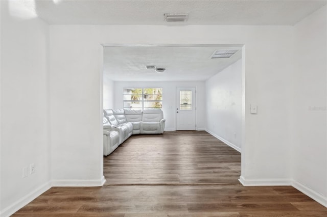 interior space featuring dark hardwood / wood-style floors and a textured ceiling