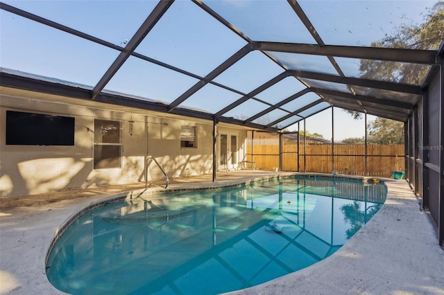 view of pool featuring a patio area and glass enclosure