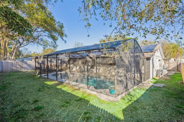 view of pool with a yard and a lanai