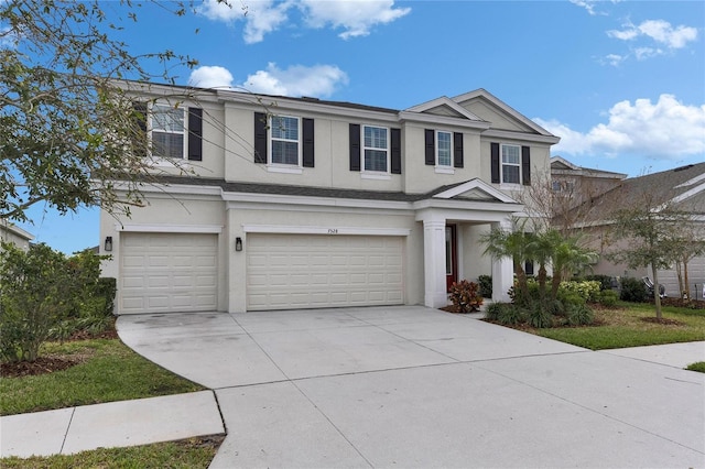 view of front of home with a garage, driveway, and stucco siding