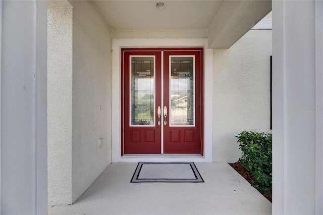 property entrance with stucco siding