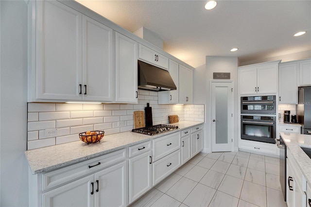 kitchen featuring tasteful backsplash, white cabinets, appliances with stainless steel finishes, under cabinet range hood, and recessed lighting