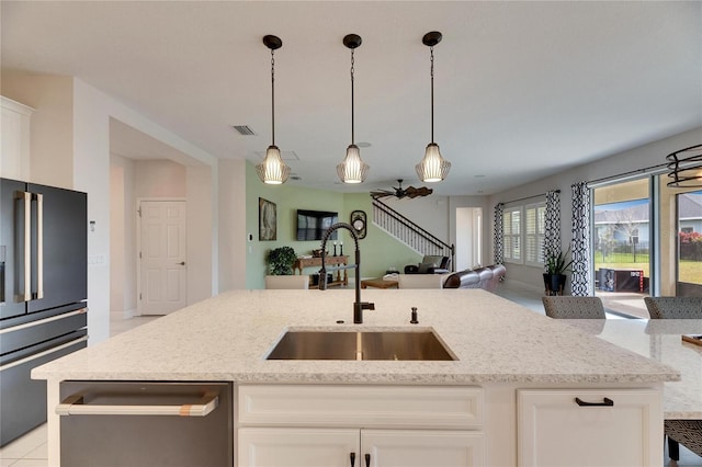 kitchen with high end fridge, visible vents, open floor plan, a sink, and dishwasher