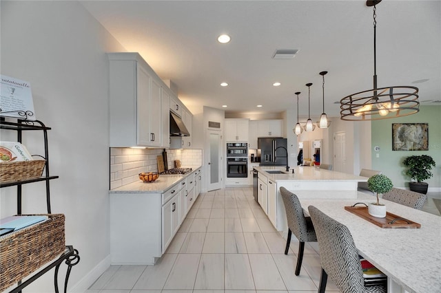 kitchen featuring visible vents, decorative backsplash, under cabinet range hood, black appliances, and a sink