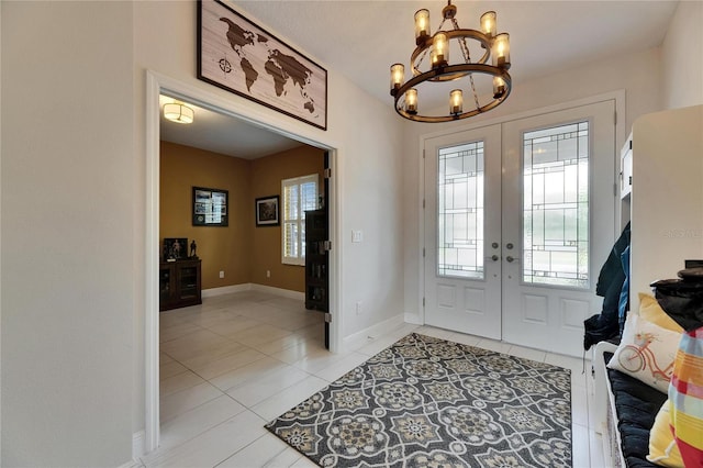 entryway with french doors, light tile patterned flooring, an inviting chandelier, and baseboards