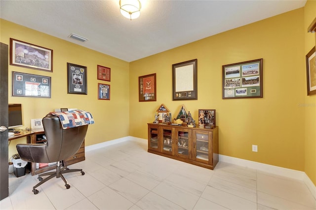 tiled office featuring visible vents and baseboards