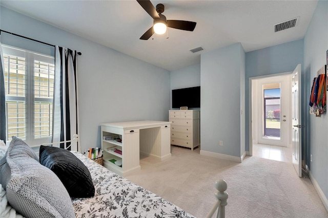 bedroom featuring baseboards, visible vents, a ceiling fan, and light colored carpet