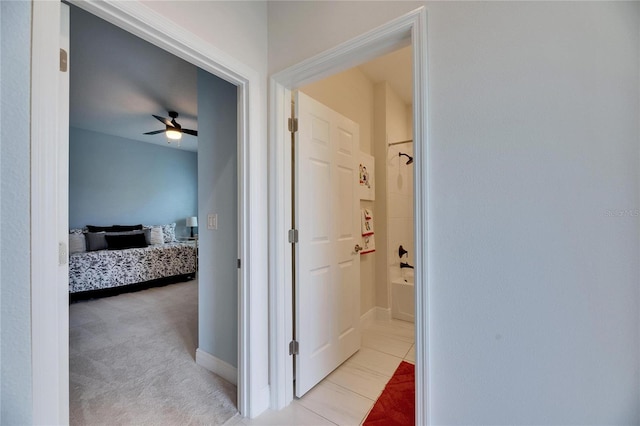 corridor with light colored carpet and baseboards