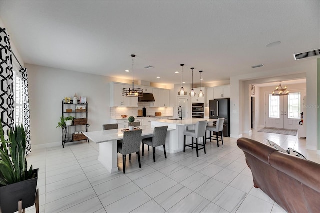 dining space featuring french doors, recessed lighting, visible vents, light tile patterned flooring, and baseboards