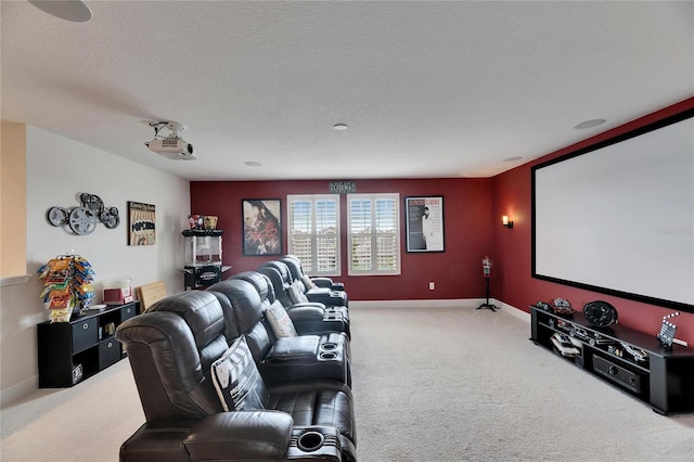 carpeted cinema room featuring baseboards and a textured ceiling