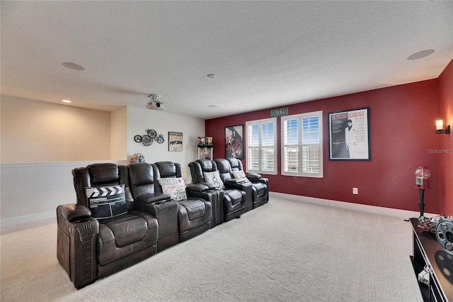 cinema room with carpet, a textured ceiling, and baseboards