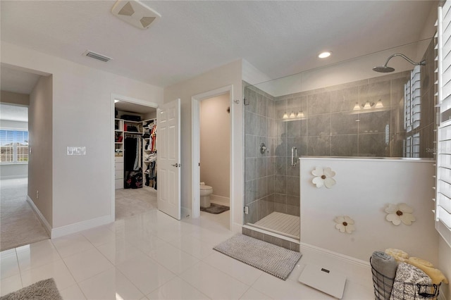 full bath featuring baseboards, visible vents, a shower stall, and toilet