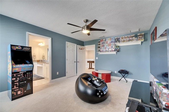 misc room with a textured ceiling, visible vents, carpet flooring, and a ceiling fan