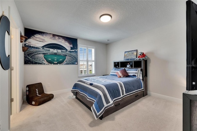 carpeted bedroom with a textured ceiling and baseboards