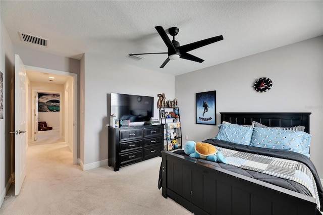 bedroom with visible vents, light carpet, ceiling fan, a textured ceiling, and baseboards