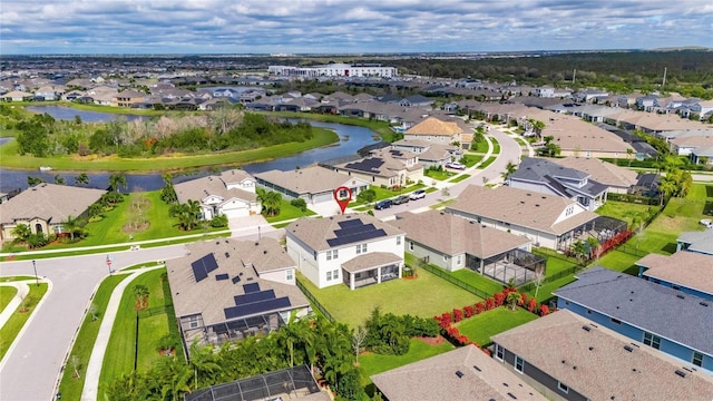 drone / aerial view featuring a water view and a residential view