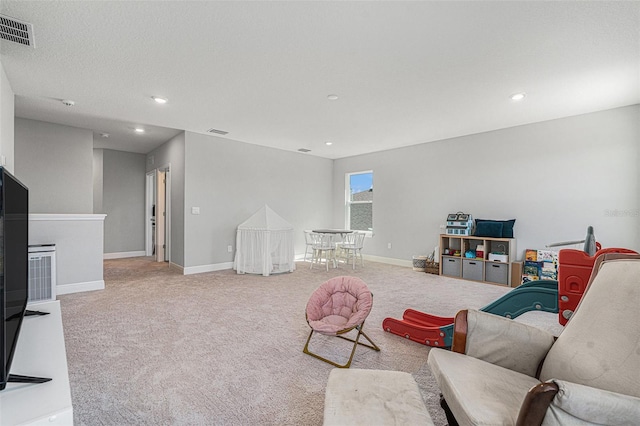 living area featuring light carpet, recessed lighting, visible vents, and baseboards