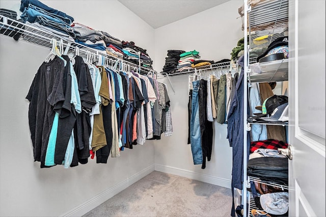 spacious closet with carpet floors