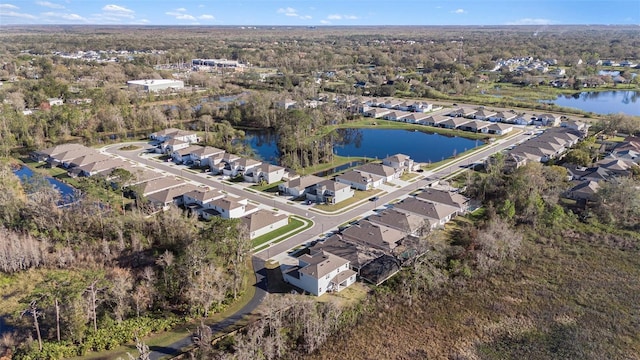 drone / aerial view with a water view and a residential view