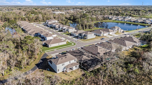 drone / aerial view featuring a water view and a residential view
