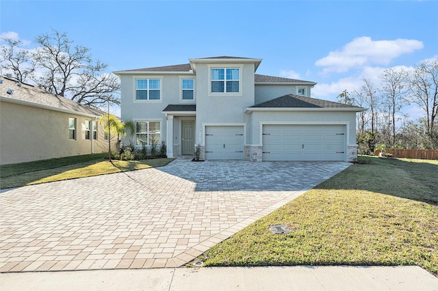 view of front of property with a front yard, decorative driveway, an attached garage, and stucco siding