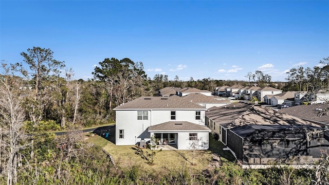 22990 Scaglione Dr, Lutz, FL 33549 - back of house with stucco siding, a residential view, a patio area, and a yard