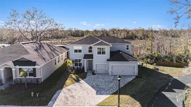 22990 Scaglione Dr, Lutz, FL 33549 - traditional home featuring stucco siding, driveway, and a garage
