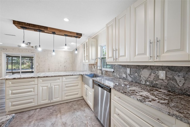 kitchen featuring pendant lighting, stainless steel dishwasher, sink, and white cabinets