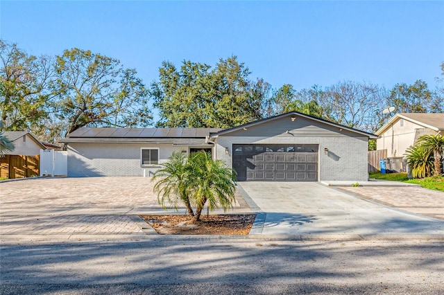 view of front of home with a garage and solar panels