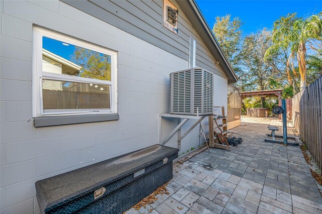 view of side of home with cooling unit and a patio area