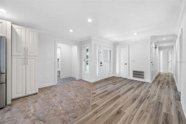 entryway with crown molding and light wood-type flooring