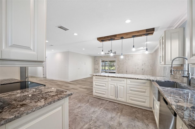 kitchen with dishwasher, white cabinetry, ornamental molding, decorative light fixtures, and dark stone counters