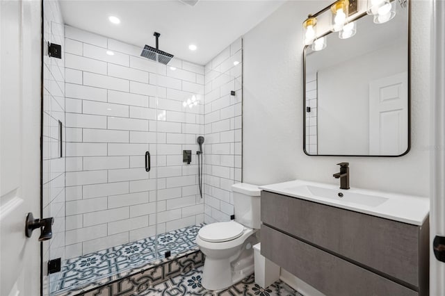 bathroom with vanity, an enclosed shower, and toilet