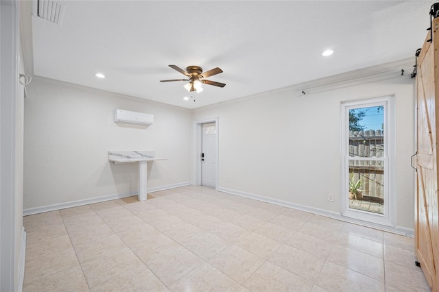 unfurnished room featuring ornamental molding, a barn door, a wall mounted air conditioner, and ceiling fan