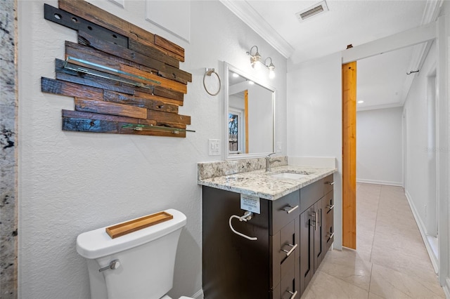 bathroom with crown molding, vanity, and toilet