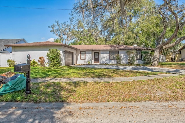 view of front of house featuring a garage and a front lawn