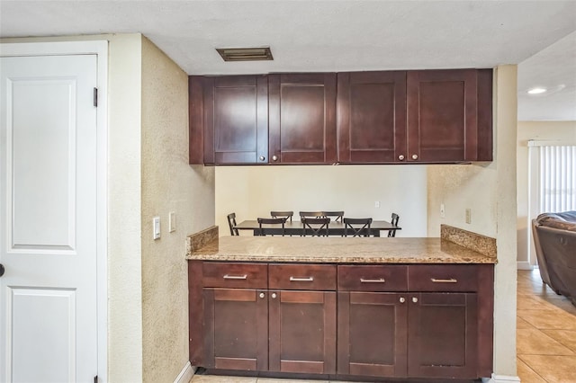 kitchen with light stone counters and light tile patterned floors