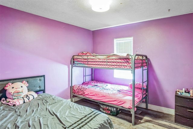 bedroom featuring wood-type flooring and a textured ceiling