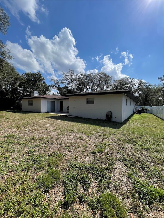 rear view of house with a yard