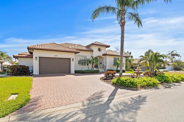 mediterranean / spanish home with a garage