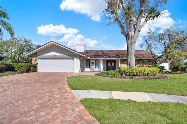 ranch-style house with a garage and a front yard