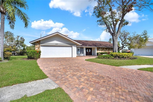 ranch-style home featuring a garage and a front lawn