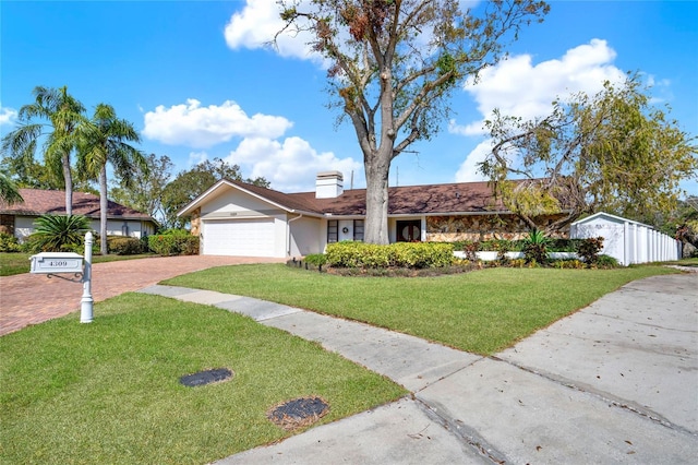 ranch-style home with a garage and a front yard