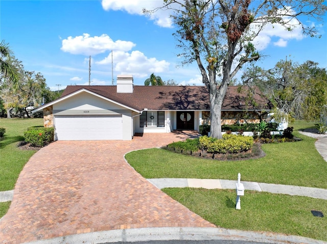 ranch-style home featuring a garage and a front yard